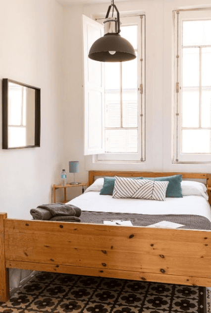 Best budget hotel in Santa Cruz de Tenerife Mapango Small Room. Simple room with wooden bedframe and two windows