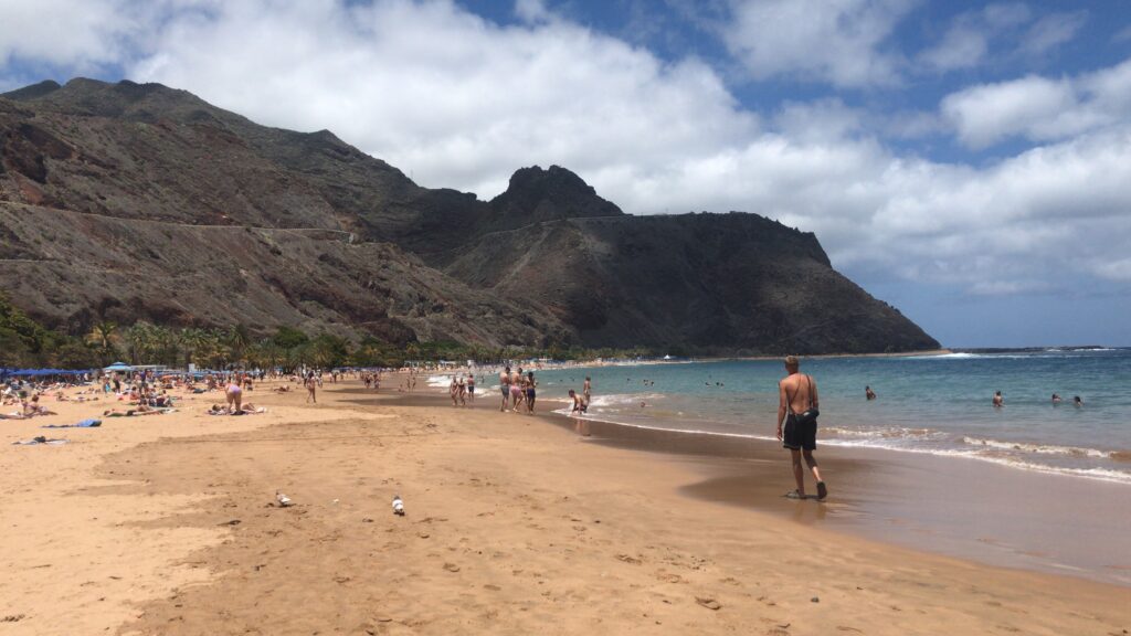 White sand beach, mountains in background. Best things to do in Santa Cuz - Las Teresitas beach