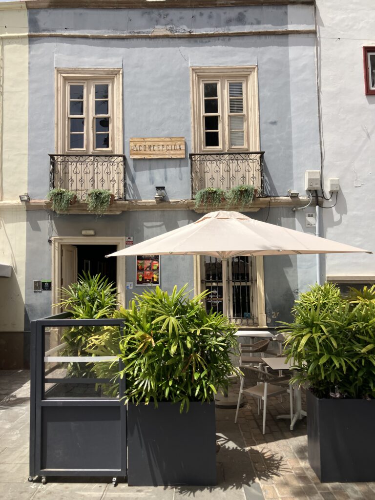 A light blue restaurant facade and small patio for seating in Santa Cruz, Tenerife