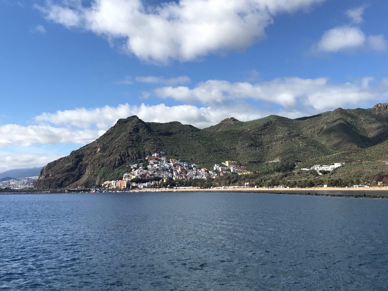 Volcanic mountains, white sand beach, the village of San Andres, Tenerife and the Atlantic Ocean