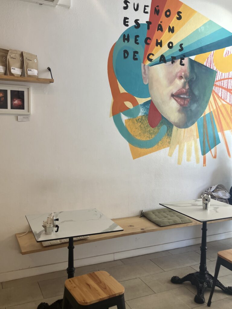 Best coffee in Santa Cruz de Tenerife. Colorful mural, two small marble tables and wooden seats.