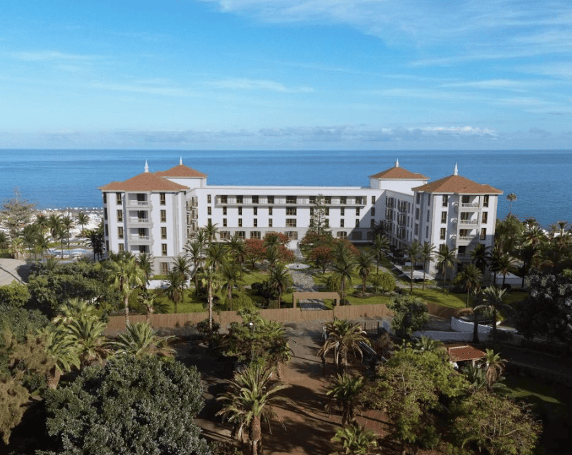 puerto de la cruz's best historic hotels - Gran Hotel Taoro. Large white building with expansive green gardens and trees surrounding