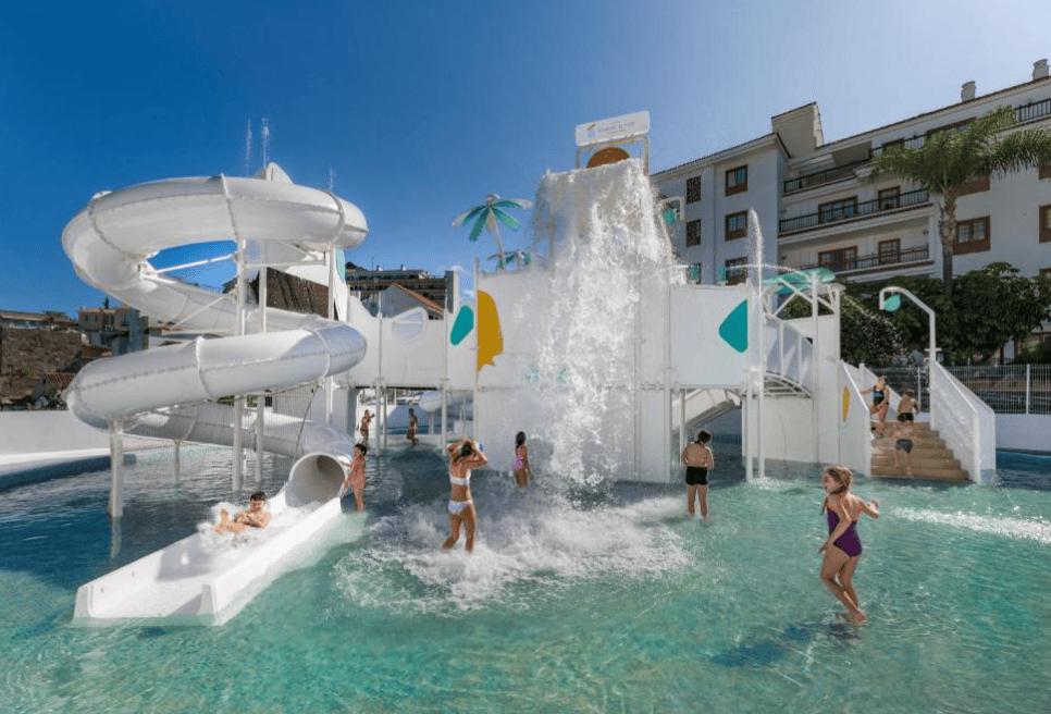 Outdoor mini water part with slide and  other water activities. Kids playing in pool at Hotel Atlantic El Tope.