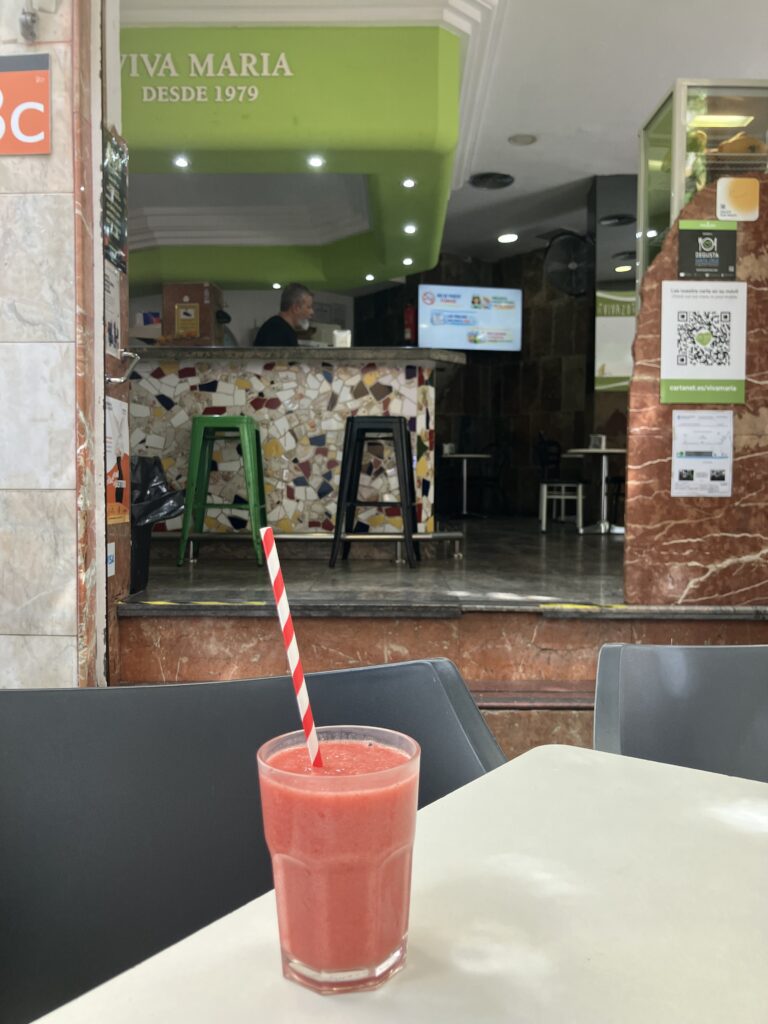 Red smooth sitting on a white table on the terrace looking into the café. Viva María café a classic breakfast spot in Santa Cruz de Tenerife