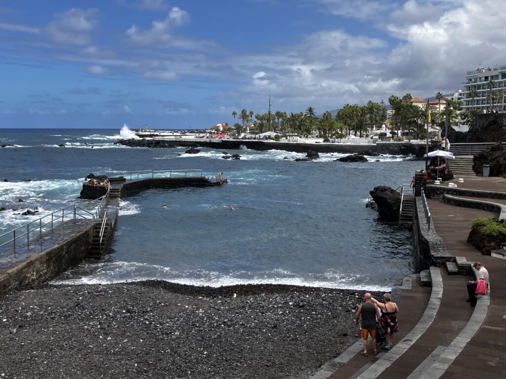 Organized entry to Atlantic ocean, rocky beach access with metal guard rail.
